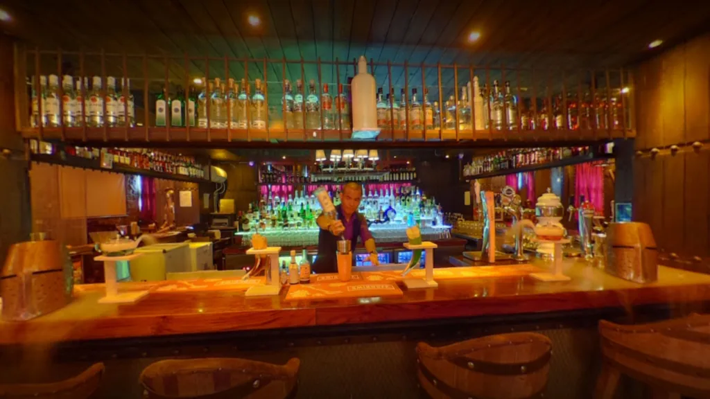 A man making drinks in a bar.