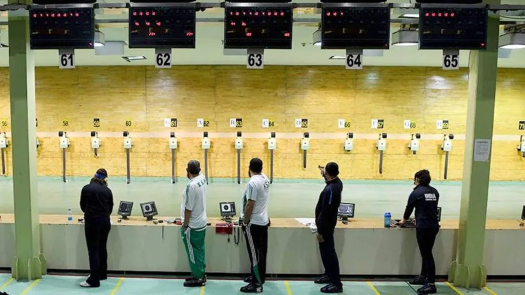 Five people practicing shooting at the range.