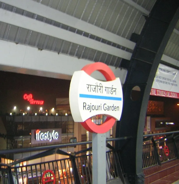 A Rajouri Garden sign board at metro station.