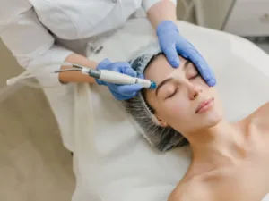 A girl taking skin treatment from a dermatologist.