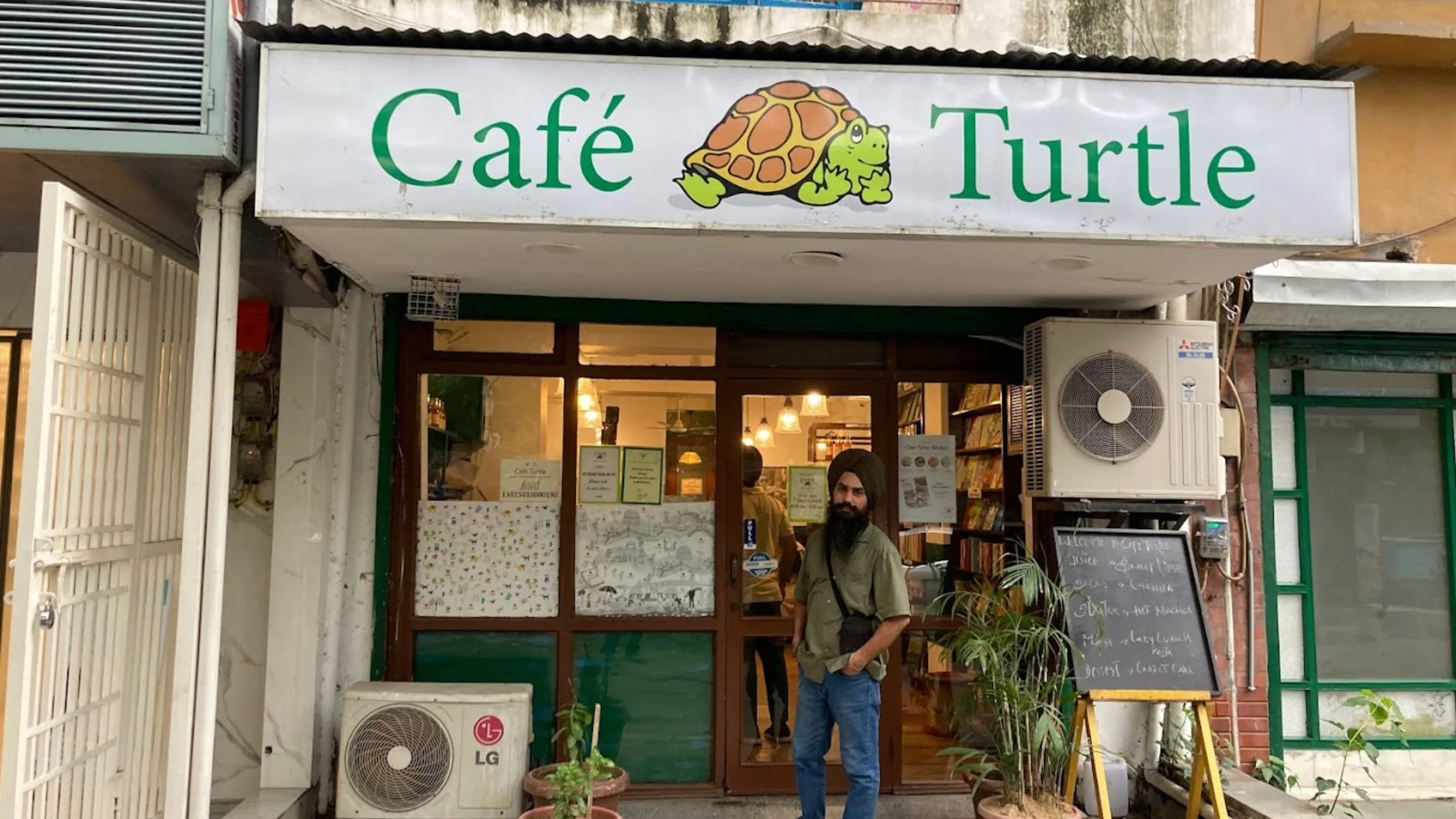 A guy taking picture outside Cafe Turle.