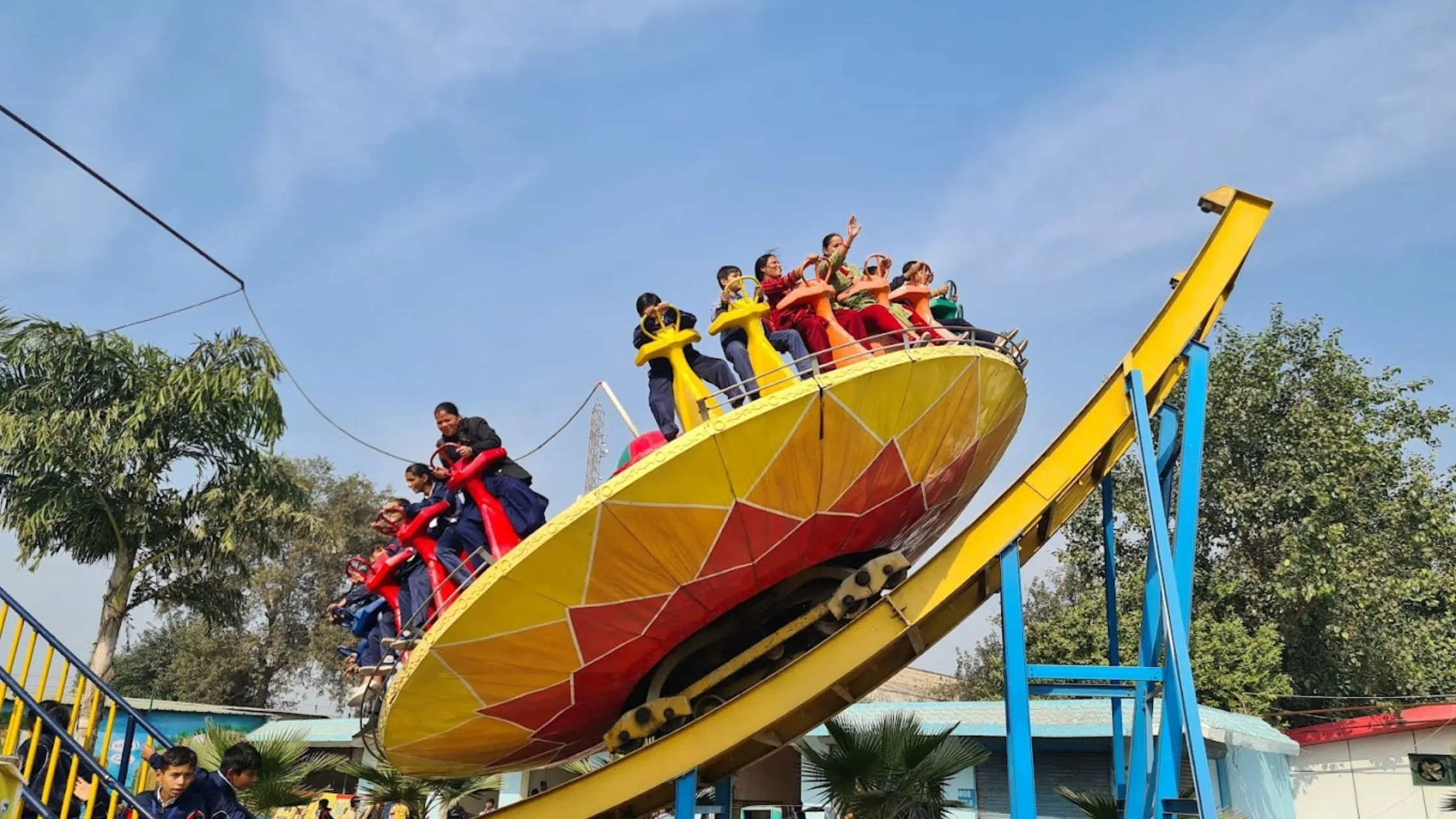 kids taking ride at amusement park in Bahadurgarh.