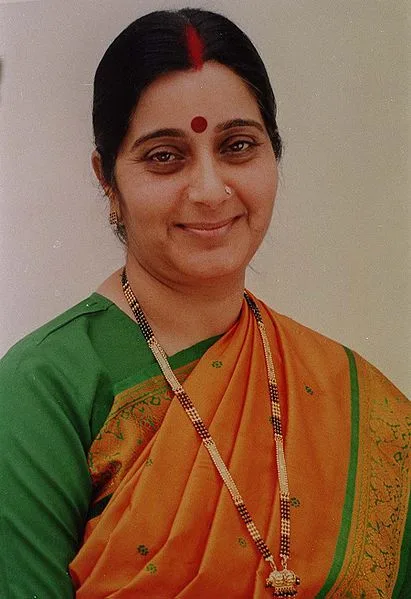 Sushma Swaraj wearing an orange saree with green blouse.