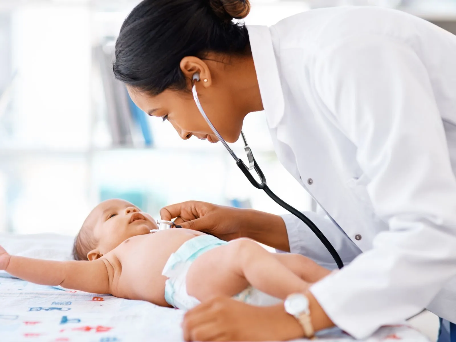 A pediatrician checking an infant.