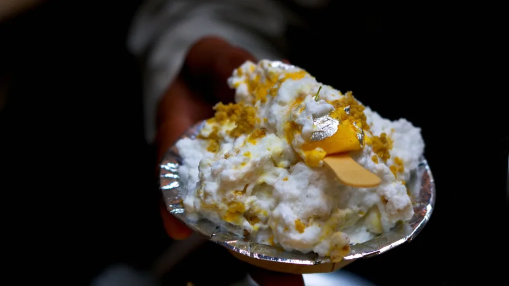 A guy holding a plate of chaat from famous Daulat ki Chaat