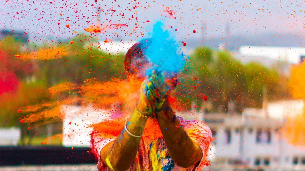 A guy playing with colors in holi 