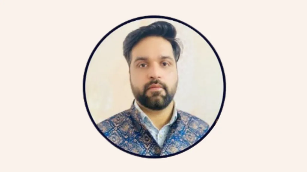 An image of Astrologer Neeraj Diwan. he is wearing light blue shirt and dark blue floral print coat. 