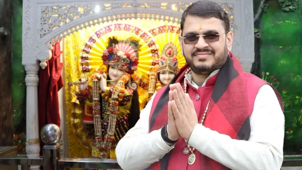 Acharya Rammehar Sharma wearing white and red colored clothes and wearing sunglasses.